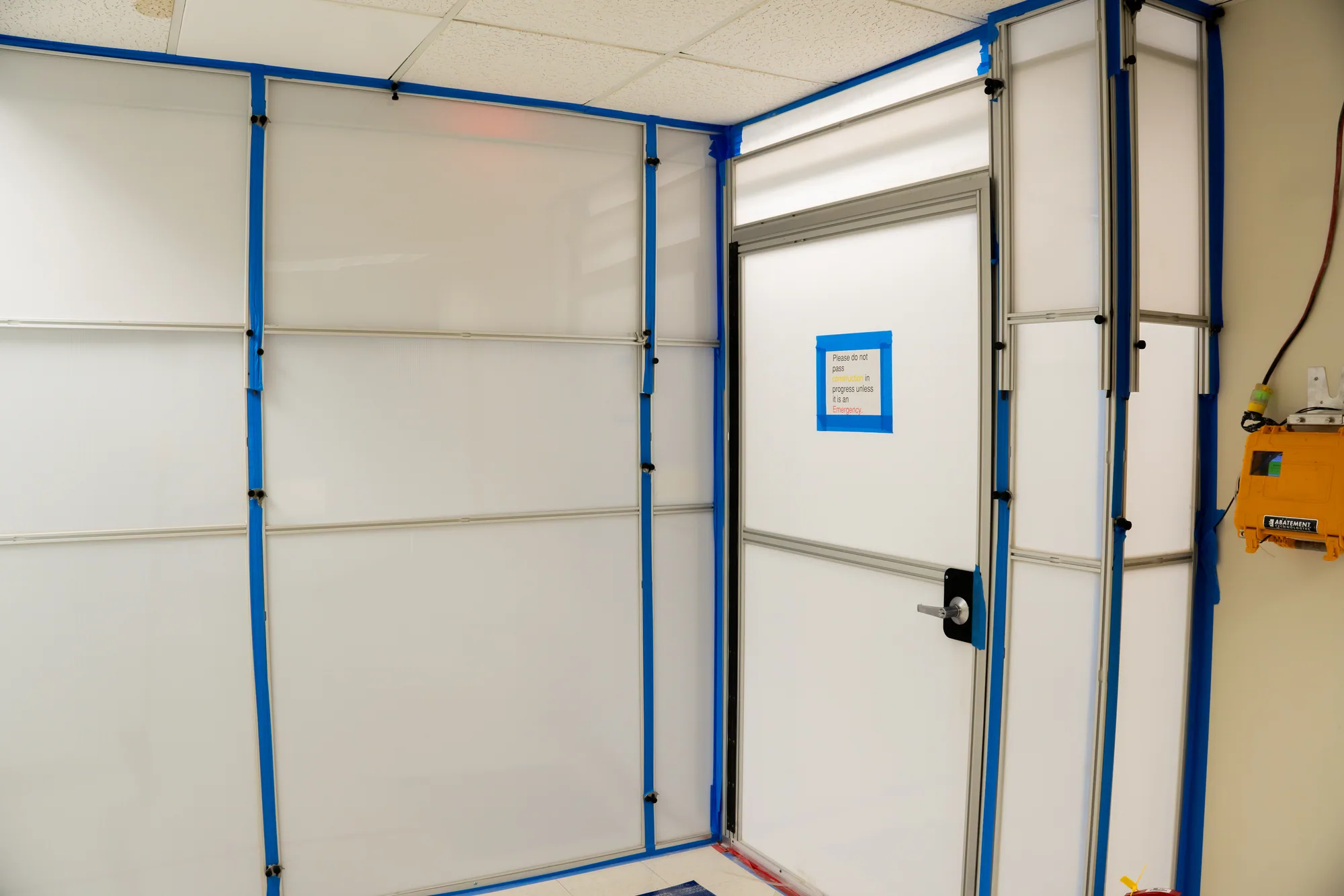 Temporary containment protecting an occupied medical-office corridor